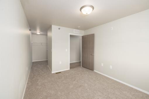 A room with a carpeted floor and a ceiling light.