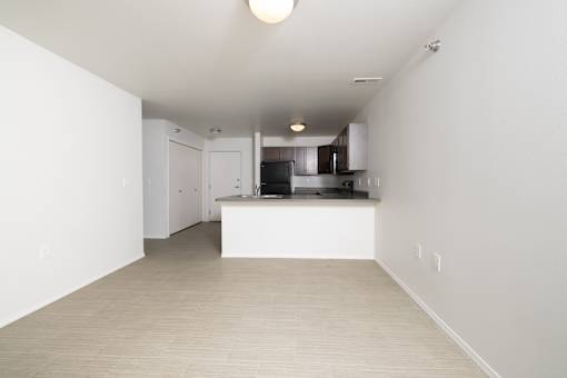 A kitchen area with a counter and cabinets.