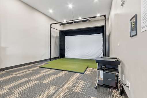 A room with a green mattress and a black table.
