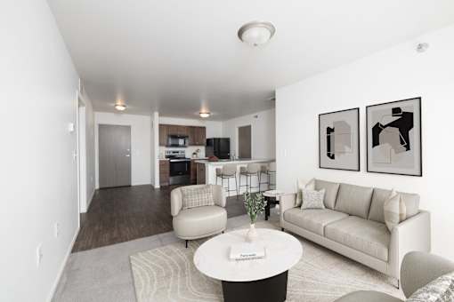 A living room with a couch, chair, and coffee table.
