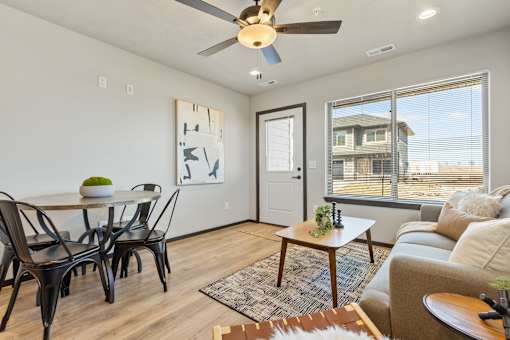 A living room with a dining table and chairs.