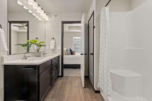 A bathroom with a white sink and a mirror above it.