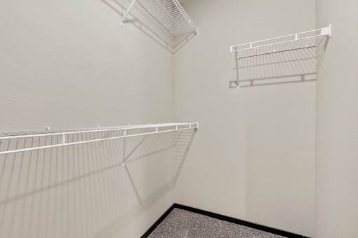 Empty white shelves in a room.