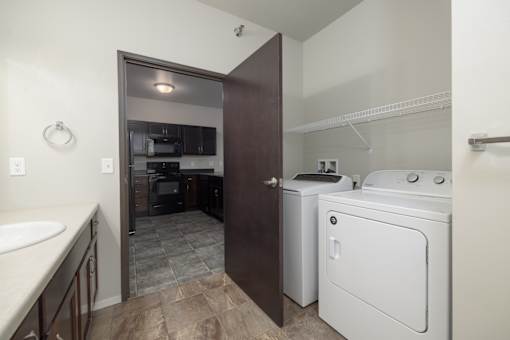 A small laundry room with a washer and dryer.