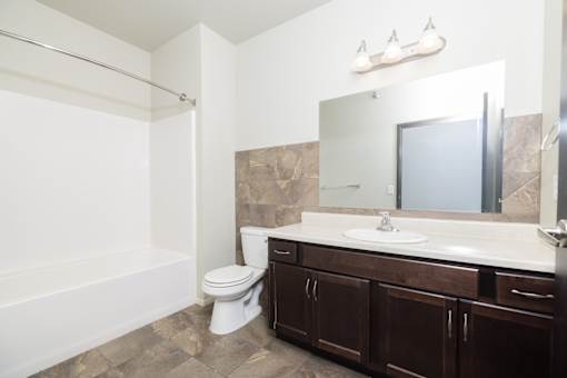 A bathroom with a white toilet and a white sink.