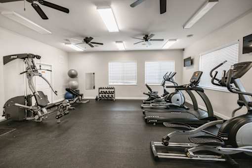 a gym with treadmills and other exercise equipment