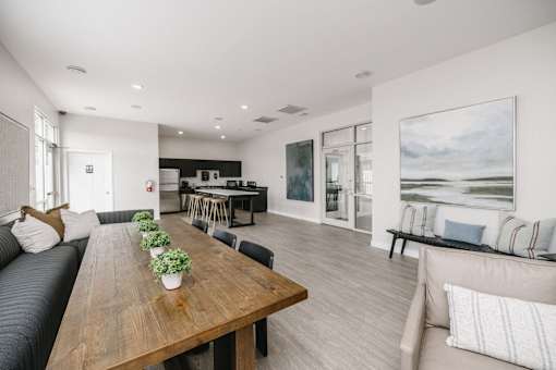 a living room and dining room with a wooden table