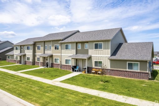 Well-maintained landscaping with manicured shrubs and paved walkways.