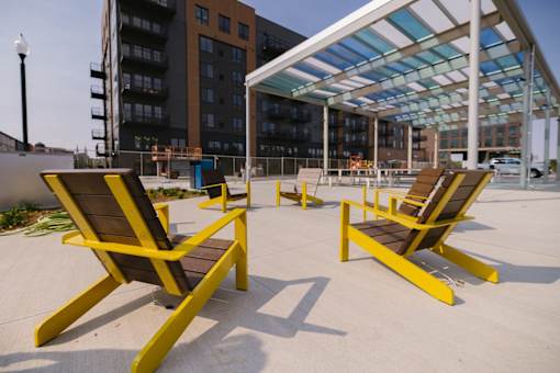 Two yellow chairs are placed on a concrete floor.