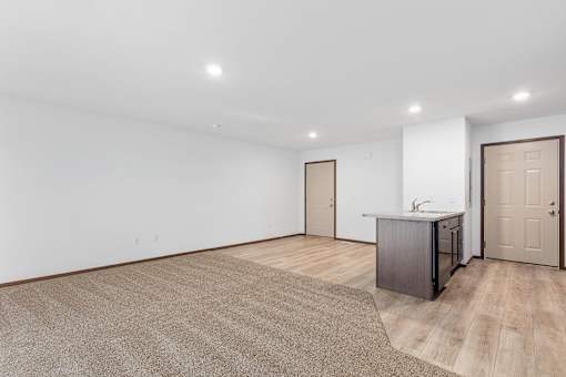 A kitchen area with a sink and cabinets is visible in the image.