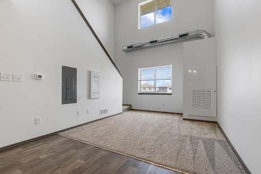 A room with a window and a door on the right side.