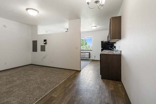 A room with a brown floor and white walls.