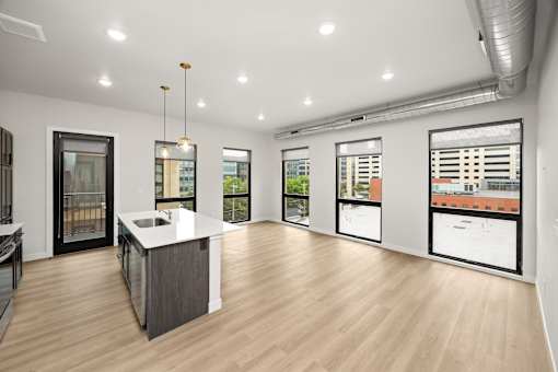 A spacious kitchen with a large island and a view of the city.