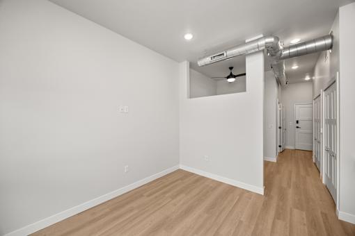A room with wooden floors and white walls.