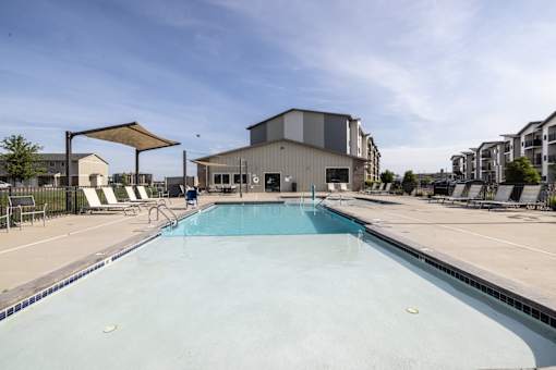 A large swimming pool in a sunny outdoor setting.
