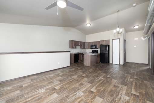 A room with a wooden floor and a ceiling fan.