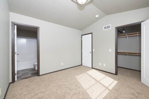 A room with a carpet on the floor and a window on the wall.