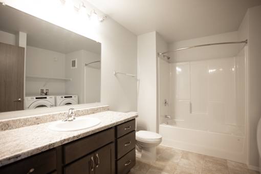 A bathroom with a sink, toilet, and bathtub.