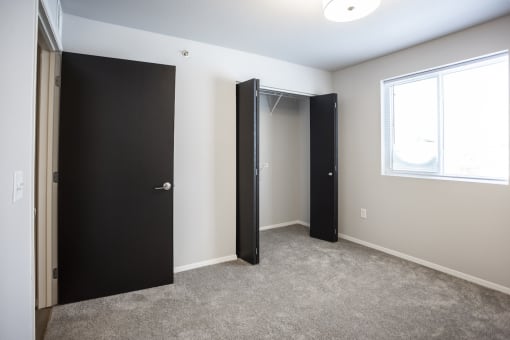 Spacious bedroom with neutral walls and ample natural light.