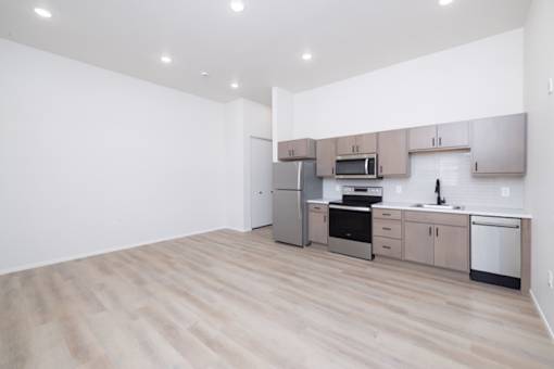 A kitchen with wooden floors and stainless steel appliances.