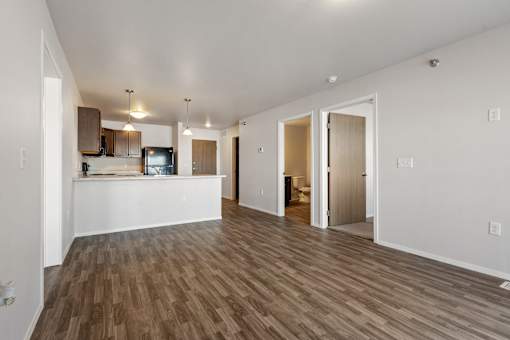 A room with a kitchen area and a living room area.