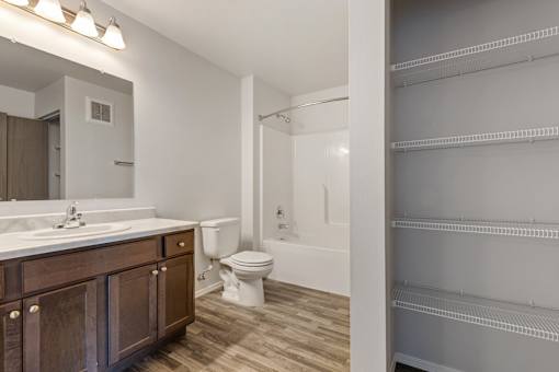 A bathroom with a toilet, sink, and bathtub.