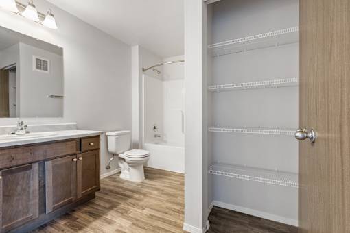 A bathroom with a toilet, sink, and a walk-in shower.
