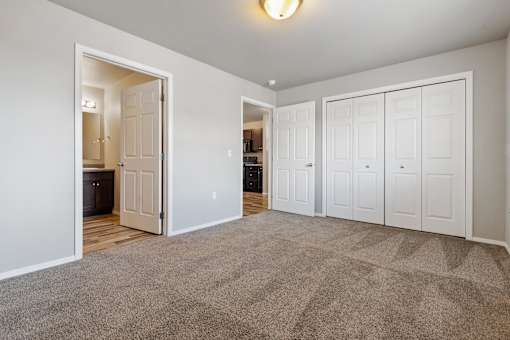 A room with a carpeted floor and white walls.