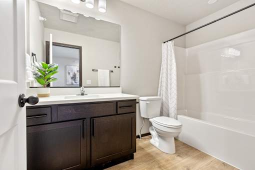 A bathroom with a white toilet and a white sink.