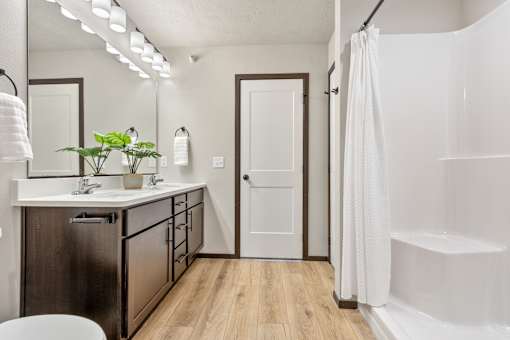 A white bathroom with a white tub and a white toilet.