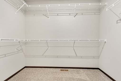 Empty room with white walls and shelves.