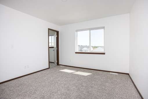 an empty room with a window and a door