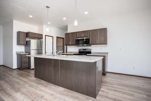 a kitchen with a large island in the middle