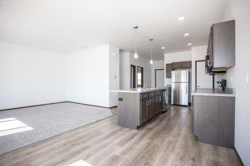 a kitchen and living room with wood flooring and