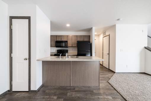 A kitchen with a black stove top oven and a black microwave.