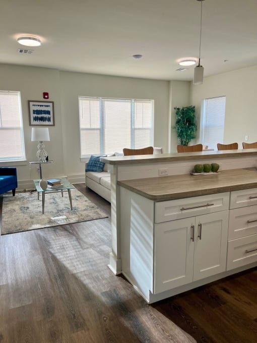a kitchen with a center island and a living room with a couch