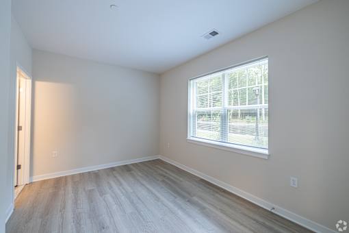 A room with a window and a door.