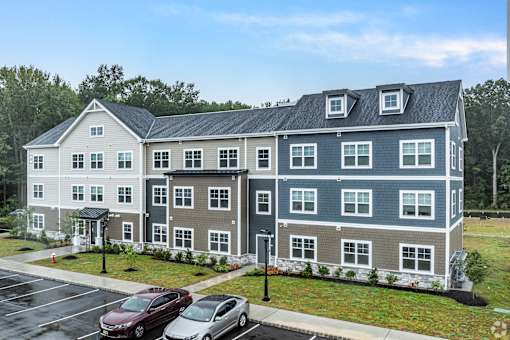A large building with a parking lot in front of it.