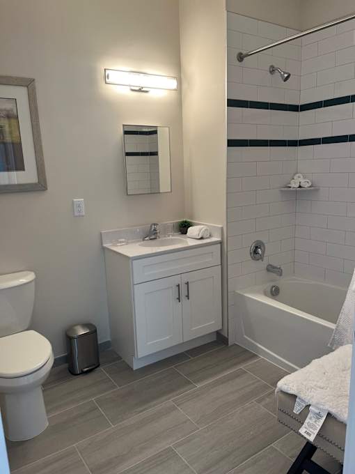A white toilet sits next to a white sink in a bathroom.