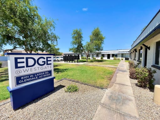 a building with a blue and white sign that says edge westgate