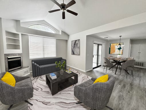 a living room with couches and a table and a ceiling fan