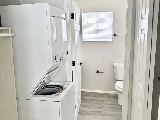 a small bathroom with a washer and dryer in it