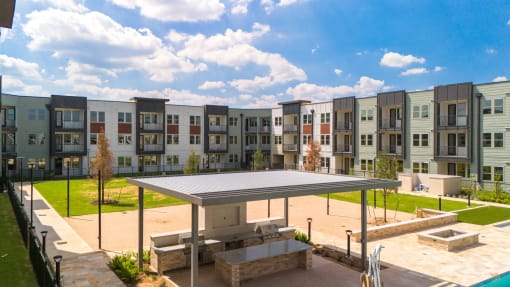 a rendering of an apartment building with multiple windows and a courtyard at Birdie on Woodland Greens, Austin