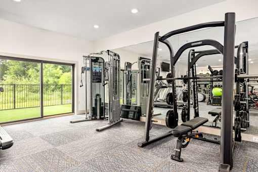 a gym with exercise equipment and a glass sliding door at Radius on Grove, Austin, TX, 78741