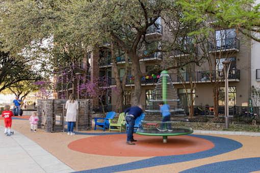 Community playground and outdoor seating area at THE'68 Apartments, Texas, 78205