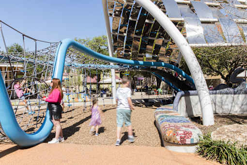 Playground with climbing structures and slides at THE'68 Apartments, San Antonio, TX