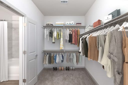 a walk in closet with a rack of clothes and a shower at Birdie on Woodland Greens, Texas