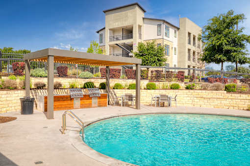 a swimming pool with a building in the background at Radius on Grove, Austin, Texas
