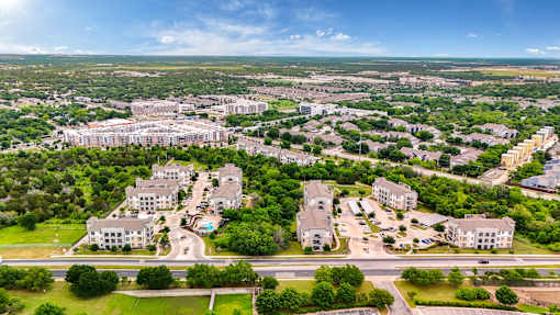 an aerial view of a suburb of a city with buildings and trees at Radius on Grove, Austin, Texas