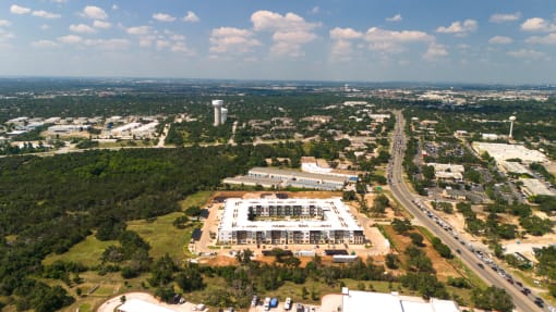an aerial view of a large building in the middle of a city at Birdie on Woodland Greens, Austin, TX